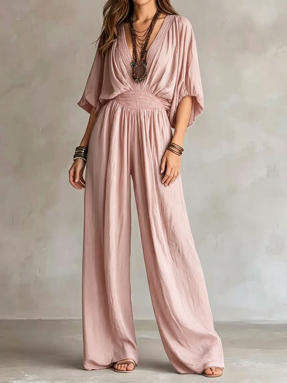 Blush pink V-neck wide-leg jumpsuit with elastic waist and draped short sleeves