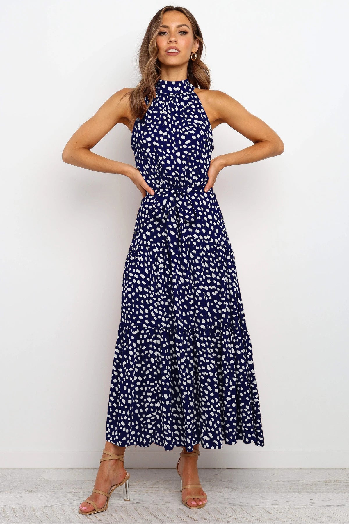 Navy sleeveless halter long dress with white polka dots and tied waist