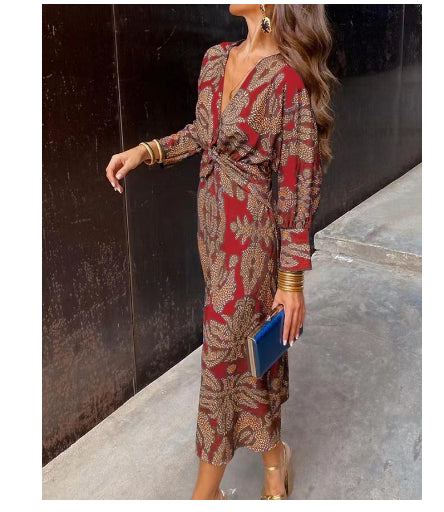 Red and tan patterned summer dress with V-neck wrap, gathered waist tie, long sleeves