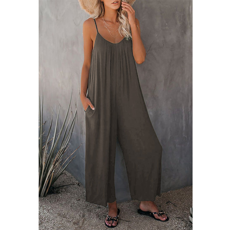 Dark gray loose jumpsuit with thin straps and wide-leg silhouette.