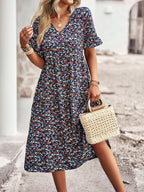 Floral V-neck midi dress in navy with short puff sleeves and gathered waist