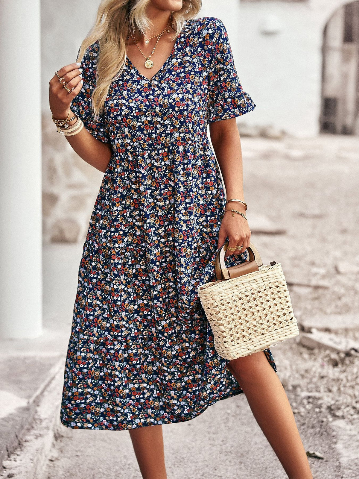 Floral V-neck midi dress in navy with short puff sleeves and gathered waist