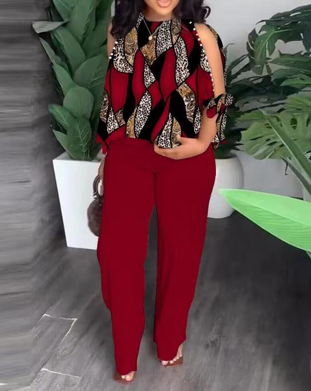Floral summer jumpsuit in dark red with sleeveless ruffle shoulders and leaf pattern top