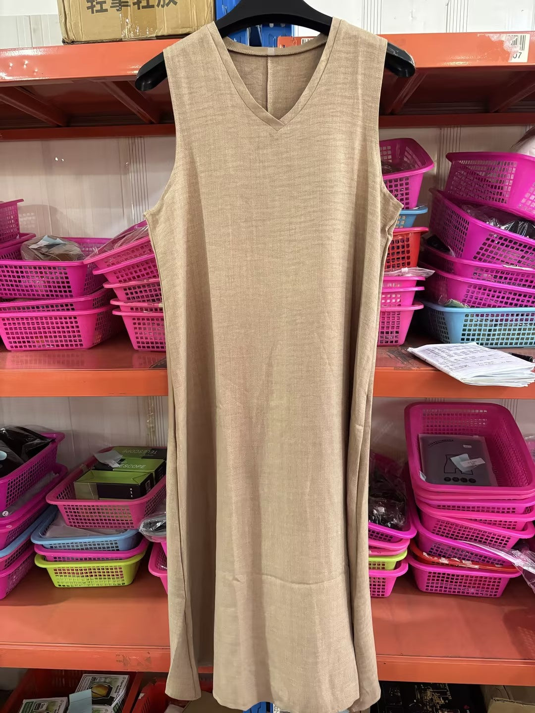Beige sleeveless V-neck maxi dress on hanger with draped linen look