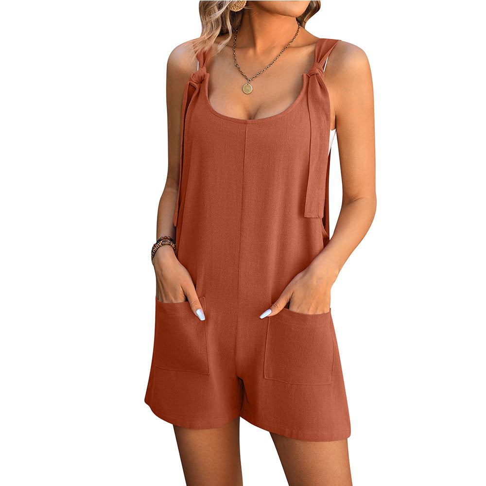 Rust orange sleeveless playsuit with tie shoulder straps and front pocket shorts.