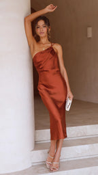 Rust brown satin one-shoulder midi slip dress with draped neckline and fitted silhouette