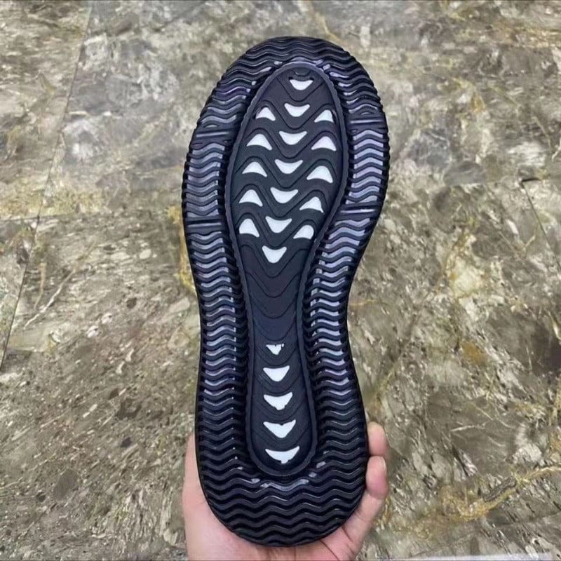 Black sneakers outsole view with wavy tread pattern