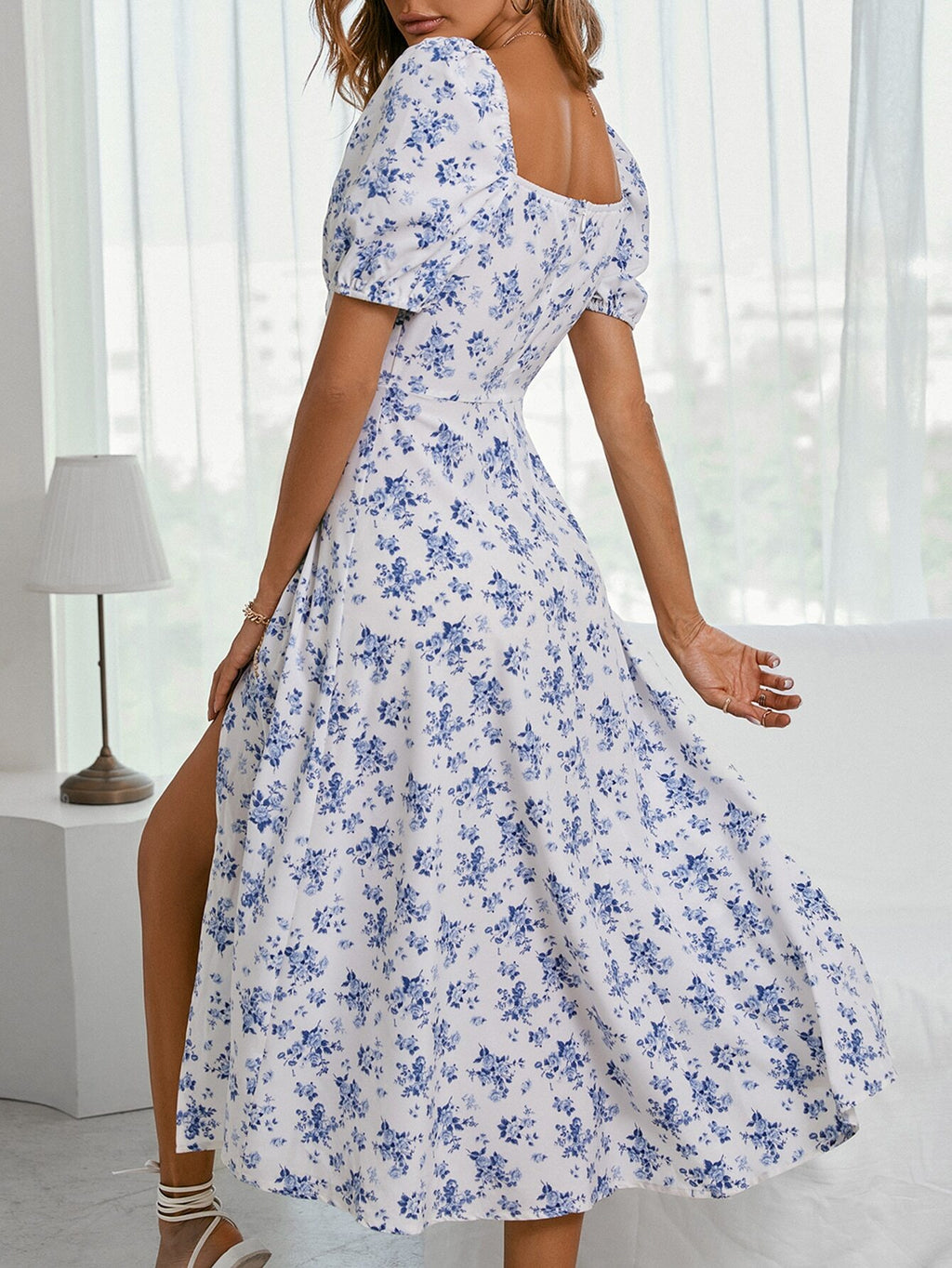 Sky blue floral maxi dress with square neckline, gathered skirt, and wide flare.