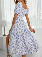 Sky blue floral maxi dress with square neckline, gathered skirt, and wide flare.