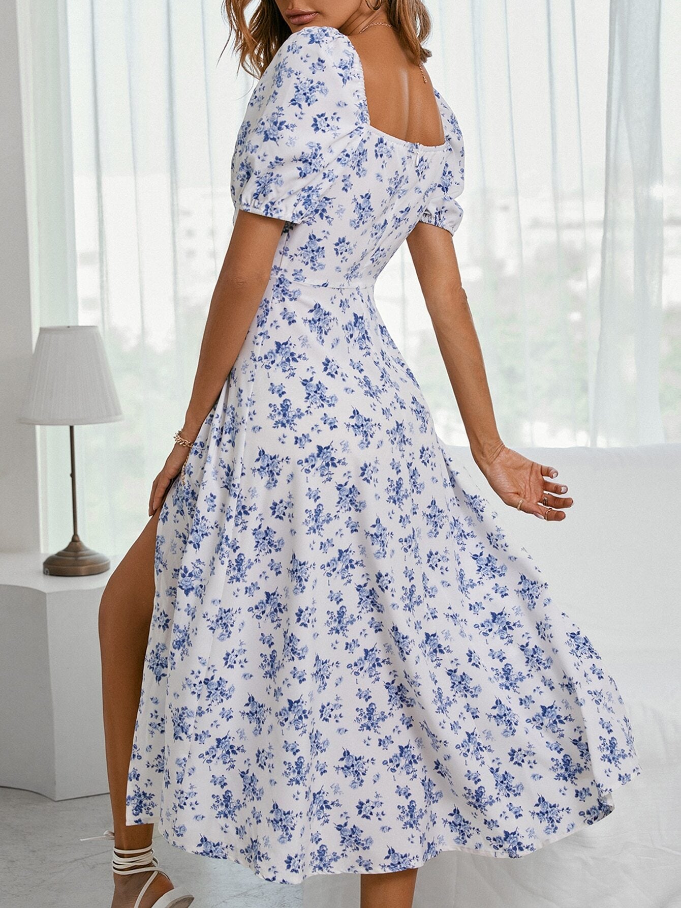 Sky blue floral maxi dress with square neckline, gathered skirt, and wide flare.