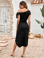 Black ruched midi dress with open back, tie shoulder bows, and high side slit