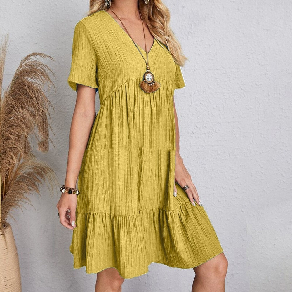 Mustard yellow V-neck short-sleeve tiered dress with gathered waist.
