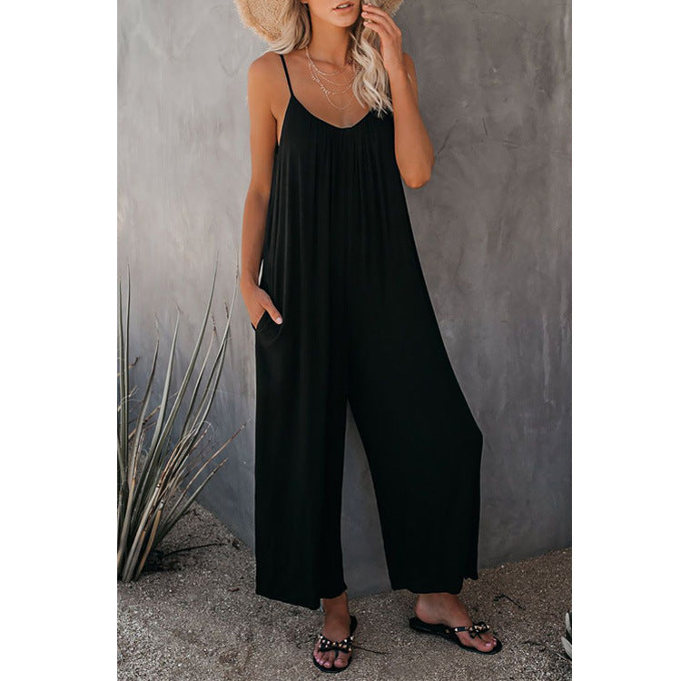Black loose-fitting jumpsuit with thin straps and wide flowing legs.
