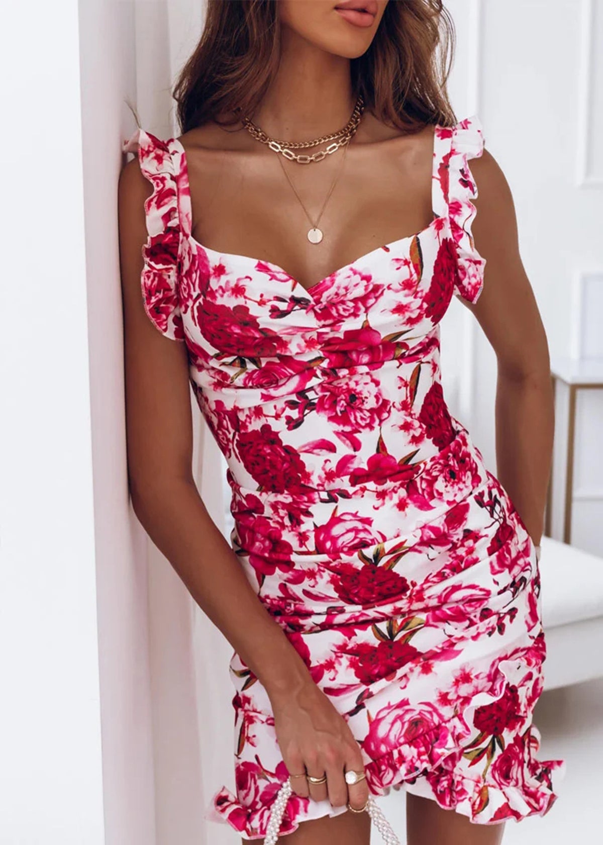 White and red floral mini dress with ruched bodice and ruffled cap sleeves