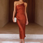 Rust red one-shoulder midi dress, sleeveless, draped bodice
