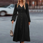 Elegant midi dress, black V-neck with button front and long puff sleeves