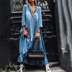Light blue tiered maxi dress with V-neck and front buttons, tassel detail at neckline