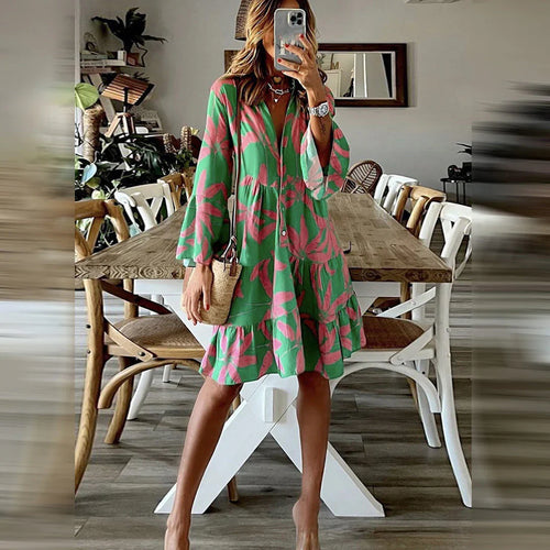 Green boho midi dress with pink leaf print, long puff sleeves, tiered skirt