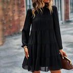 Elegant black tiered mini dress with long sleeves and ruffled bands