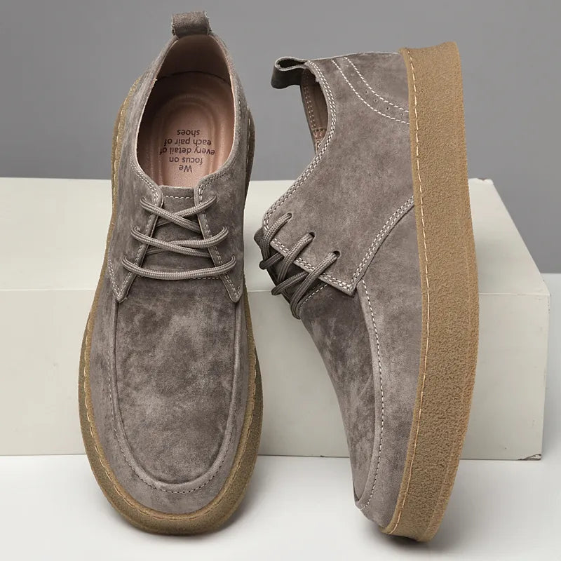 Suede lace-up sneakers with gum rubber sole, paired shoes on display