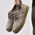 Suede lace-up sneakers with round toe and gum rubber sole, side profile view
