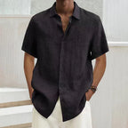 Dark charcoal short-sleeve button-up shirt with point collar and button front