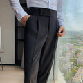 Black dress pants with button closure, belt loops, and neatly pressed pleats