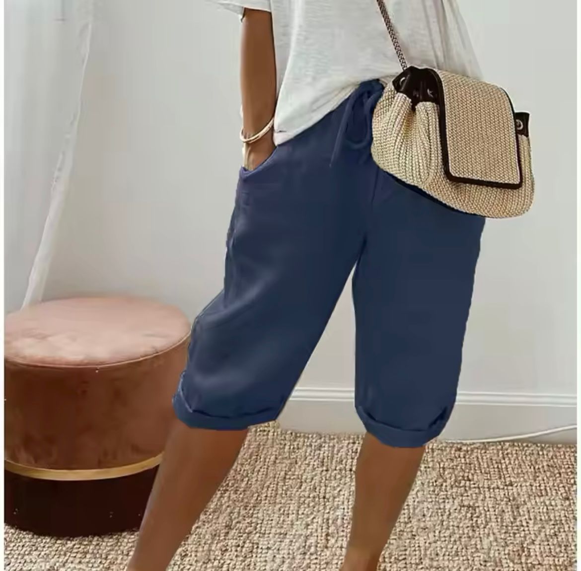 Navy blue cropped womens pants with drawstring waist and relaxed cuffed hem