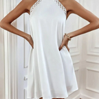 White halter mini dress with lace trim, sleeveless A-line silhouette