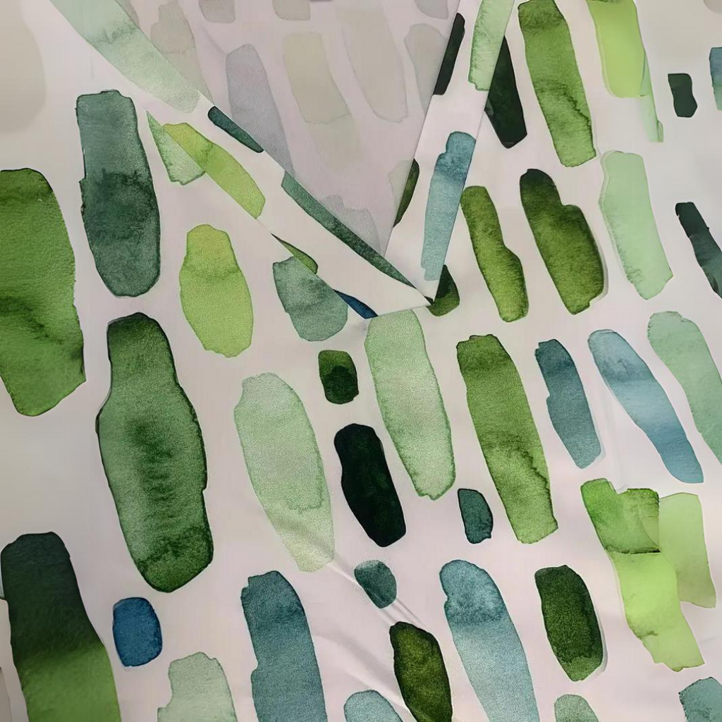Blouse fabric close-up: green, blue, and white vertical abstract brush print