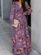 Purple floral maxi dress with V-neck and long bell sleeves, tiered skirt