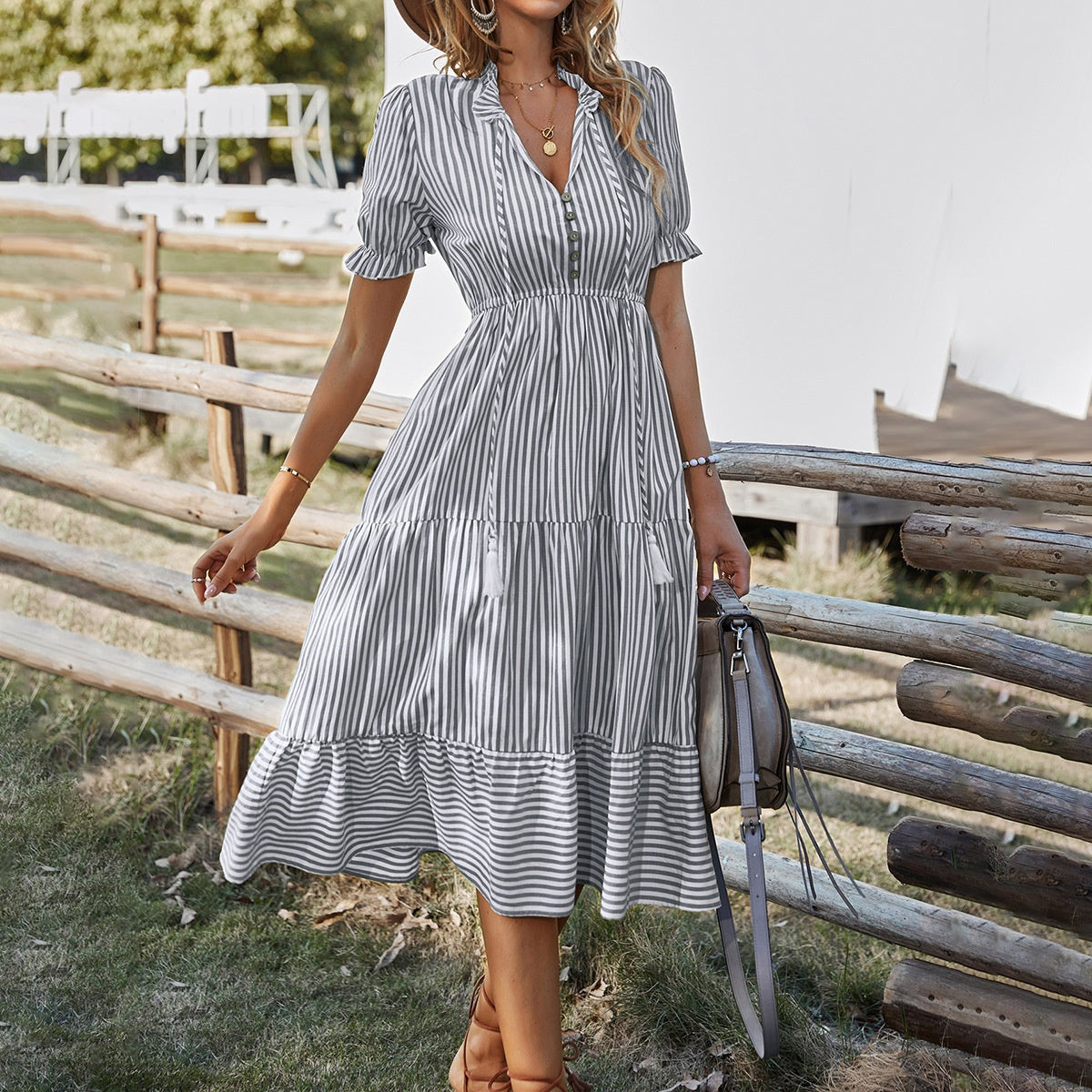 Gray striped midi shirt dress with tiered skirt, puff sleeves, and button front