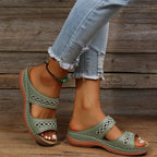Green slide sandals with cutout stitched detail, two straps, and cushioned sole