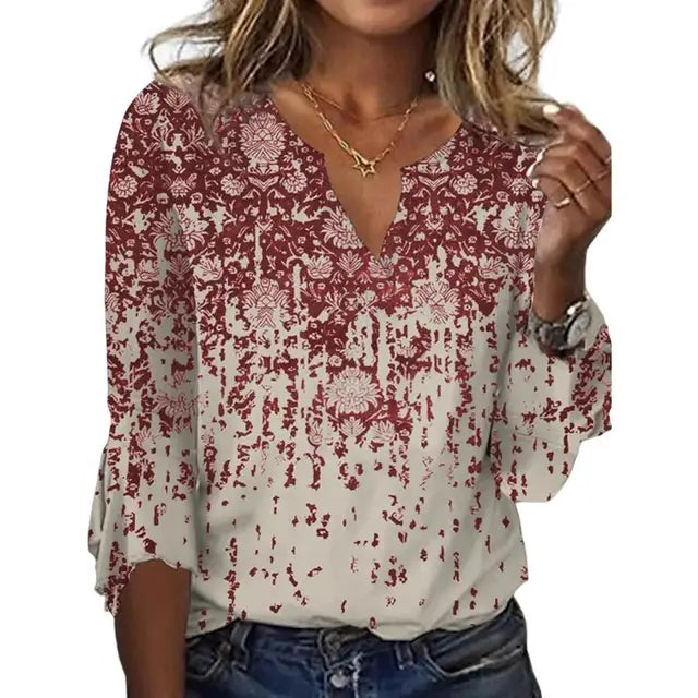 Women's airy blouse top with red-and-white damask-style abstract print and V-neck