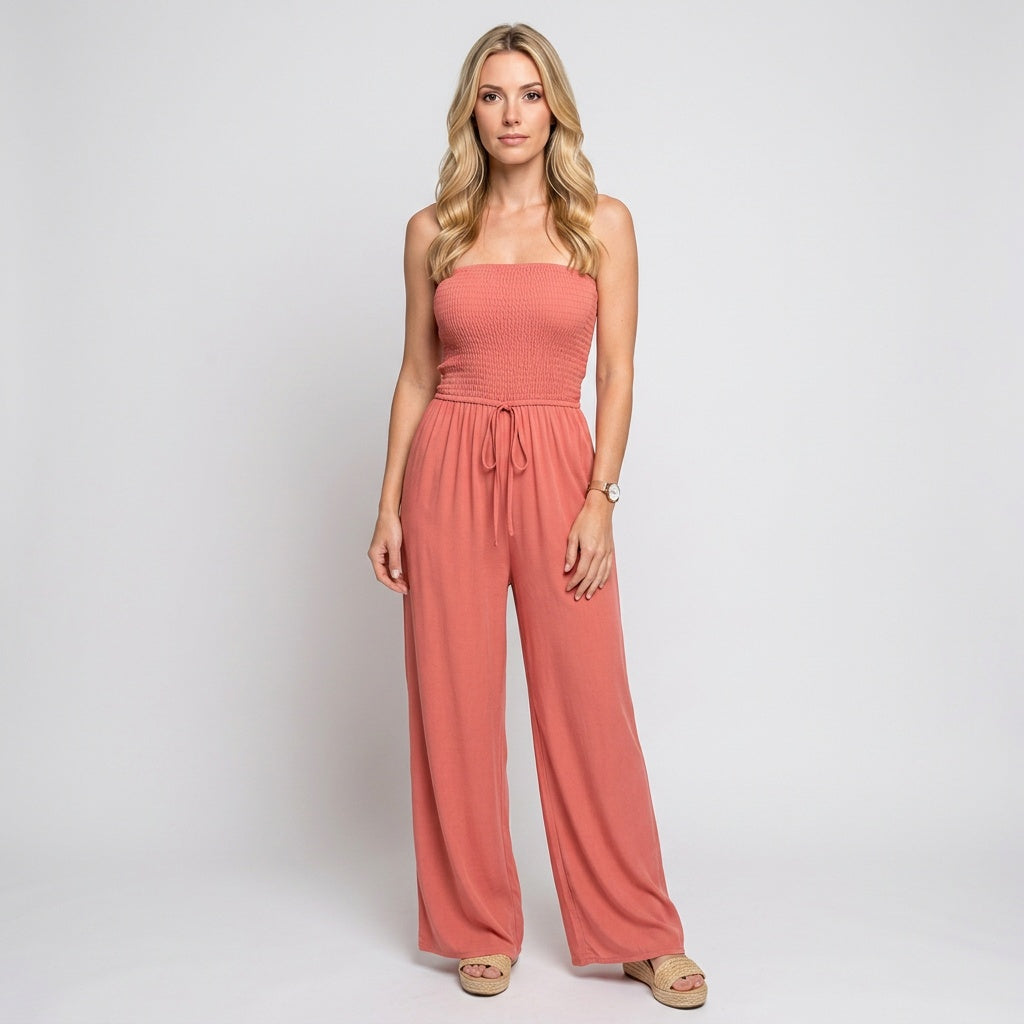 Coral orange strapless smocked jumpsuit with drawstring waist and wide-leg pants