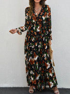 Dark floral maxi dress with V-neck, long sleeves, and ruffle tiers