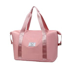 Pink waterproof sleeping bag carrier with top handles and side carry straps