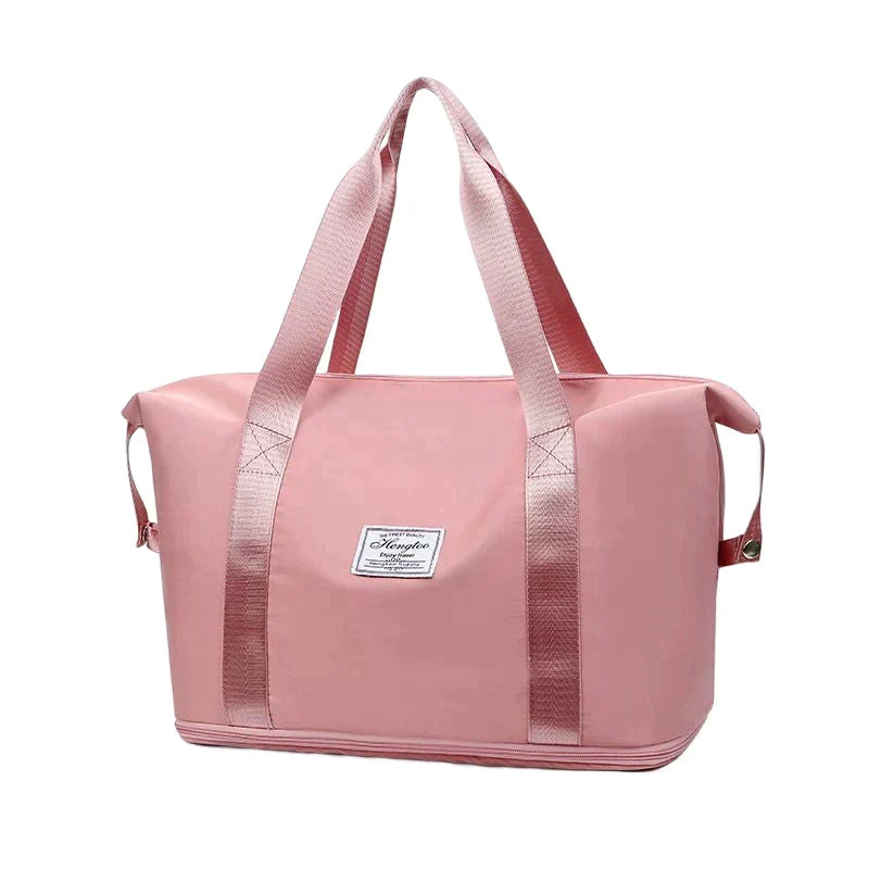 Pink waterproof sleeping bag carrier with top handles and side carry straps