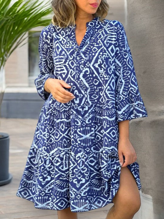 Women's summer dress in royal blue with white geometric print, V-neck, and tiered skirt