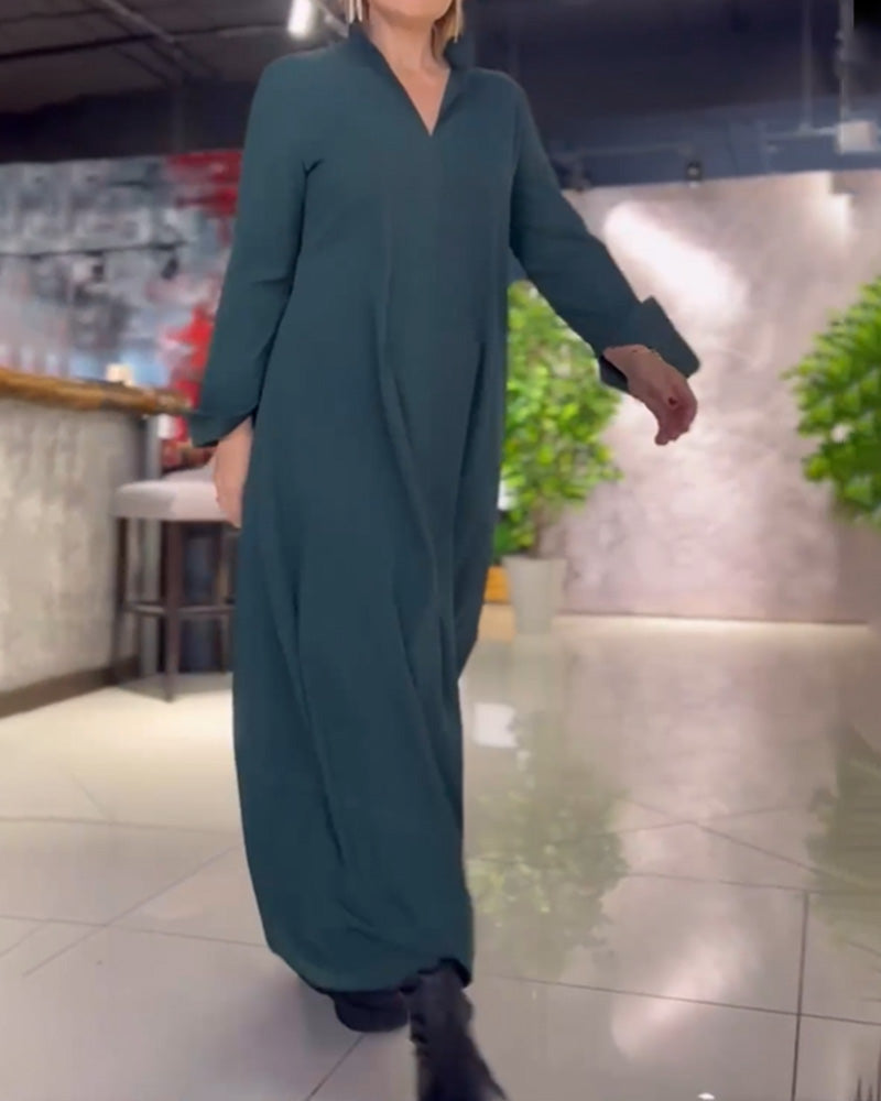 Dark teal V-neck maxi dress with three-quarter sleeves and flowing wrap-style waist.