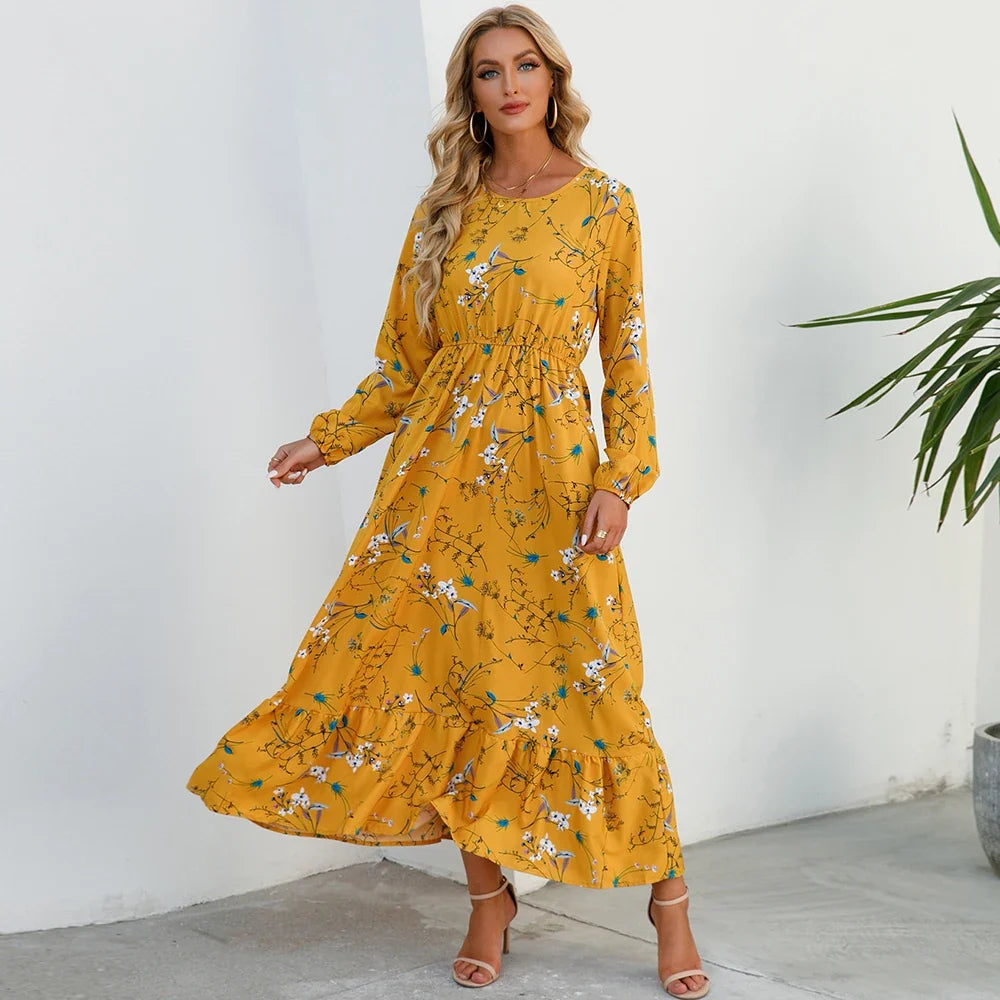 Mustard yellow floral maxi dress with long sleeves, elastic waist, and tiered skirt