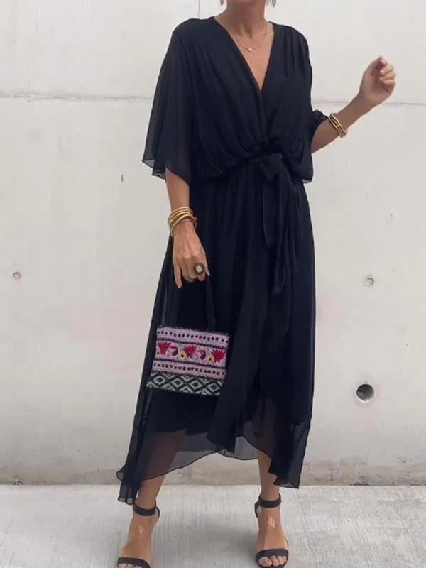 Black V-neck wrap summer dress with waist tie and sheer flowing sleeves.