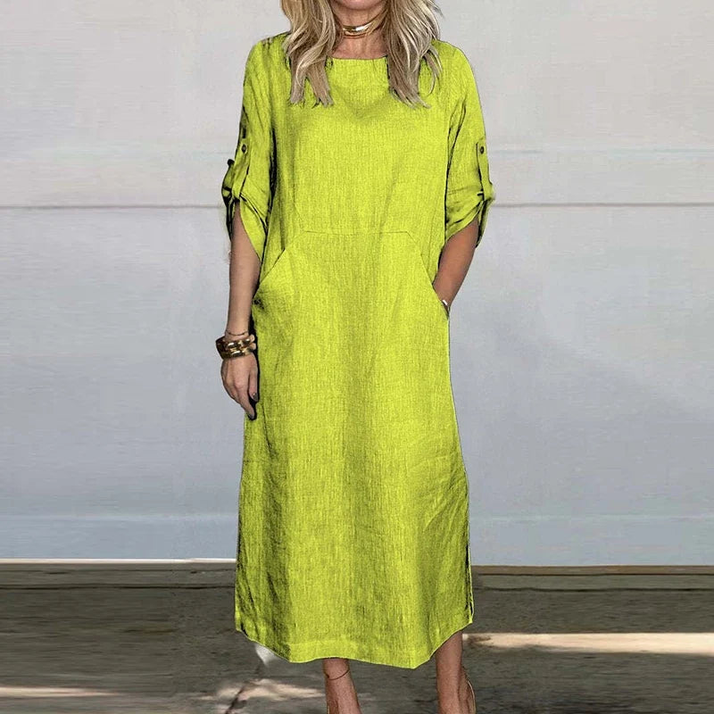 Bright green textured midi dress, crew neck, short sleeves with button details.
