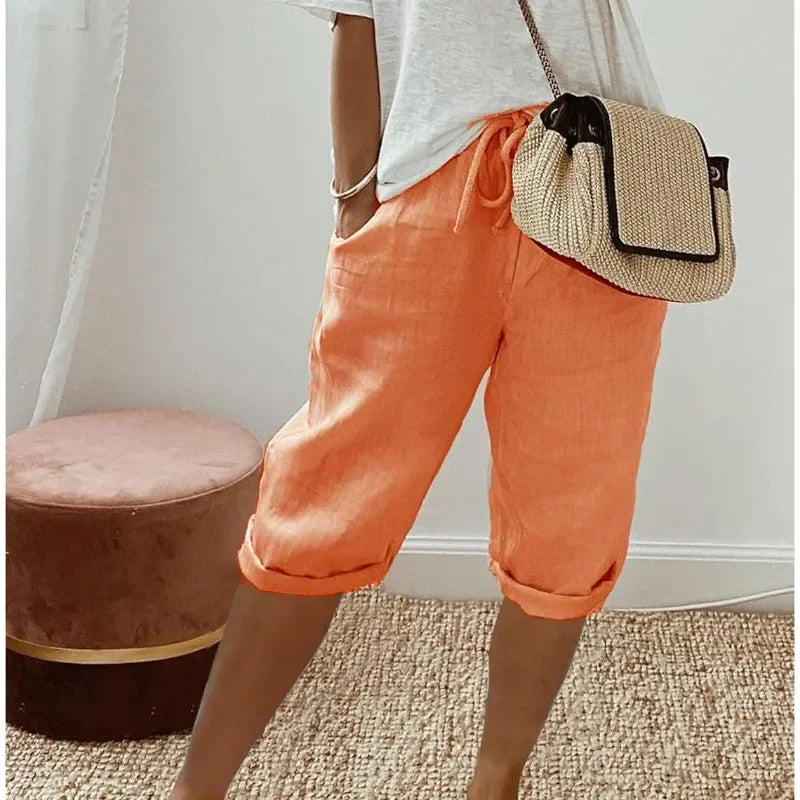 Orange cropped womens pants with drawstring waist and relaxed cuffed hem