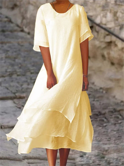 Pale yellow long midi dress with short sleeves, round neck, and layered ruffle hem