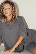 Women’s dark gray lounge set with short-sleeve top and matching biker shorts.