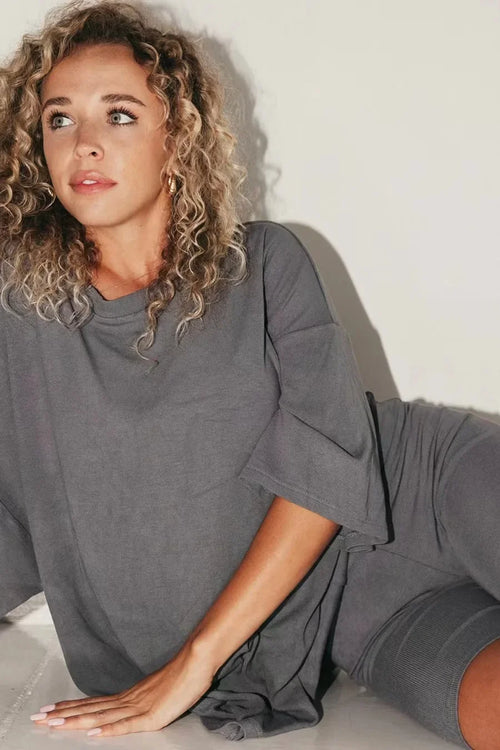Women’s dark gray lounge set with short-sleeve top and matching biker shorts.