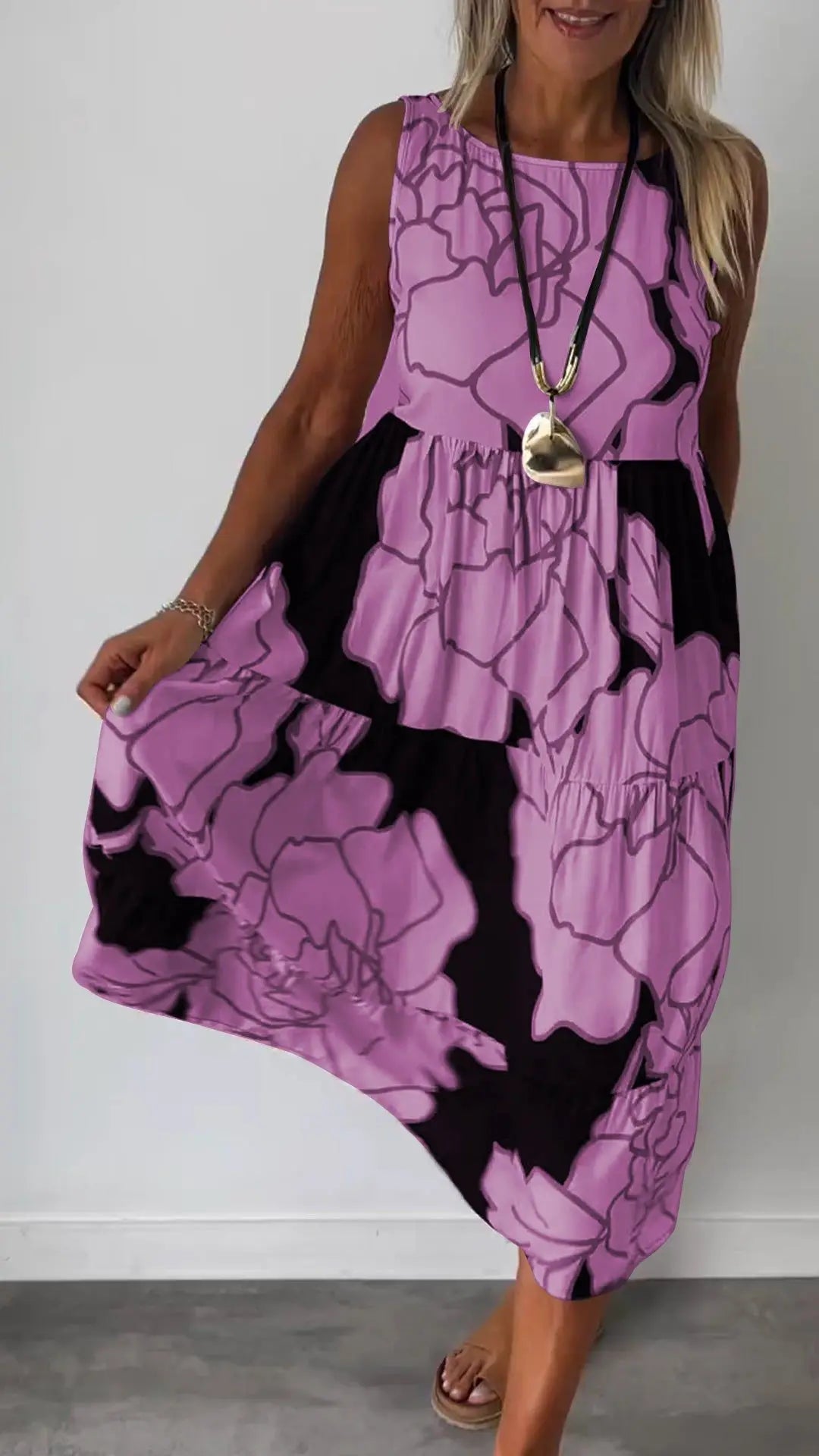 Sleeveless printed midi dress with round neckline and flowing tiered skirt, purple.