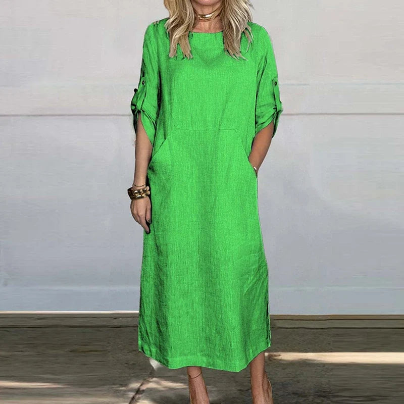 Vivid green textured midi dress, crew neck, short sleeves with button details.