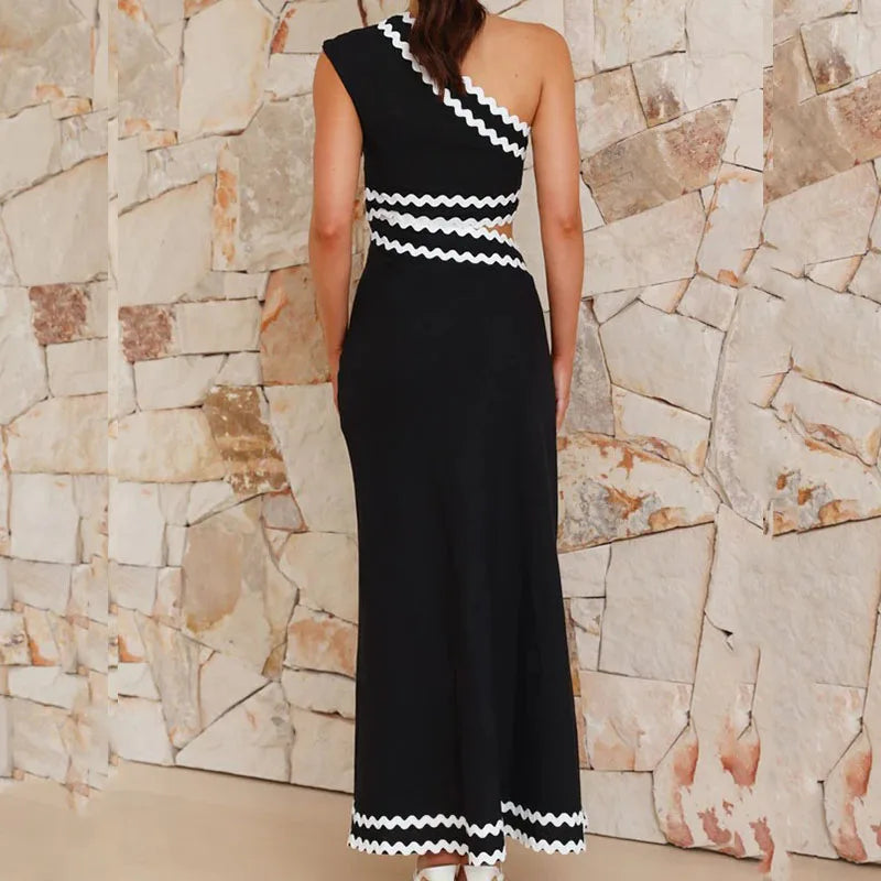Black one-shoulder maxi dress with layered zigzag stripe panels and contrast hem trim